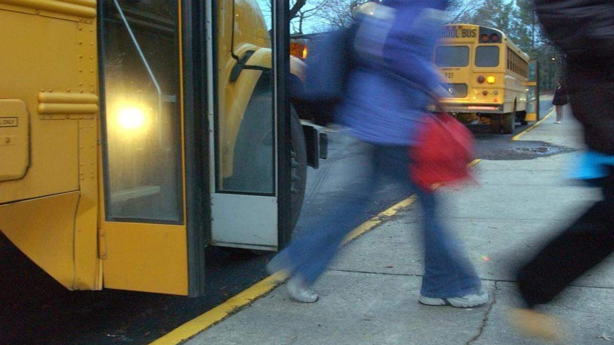 Students arriving at Carroll Middle School in Raleigh get off their buses and head into the school building in this 2004 photo.
