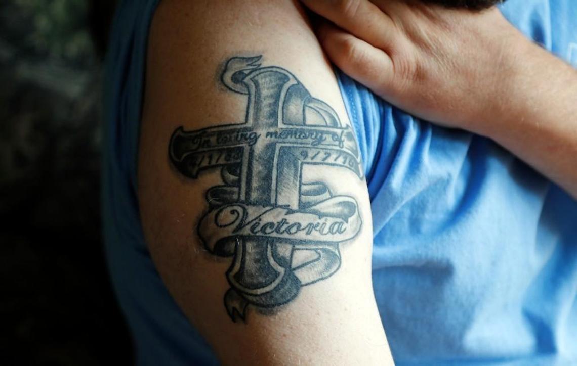 Charles Short, husband of Victoria Christine Short, shows a tattoo he got in her memory.