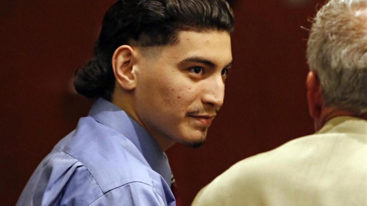 Murder defendant Jonathan Santillan, 18, listens to his defense attorney Jeff Cutler after the Santillan jury came back in to the courtroom to examine two pieces of evidence before going back to their deliberations in Wake Superior Court on Aug. 28, 2015.