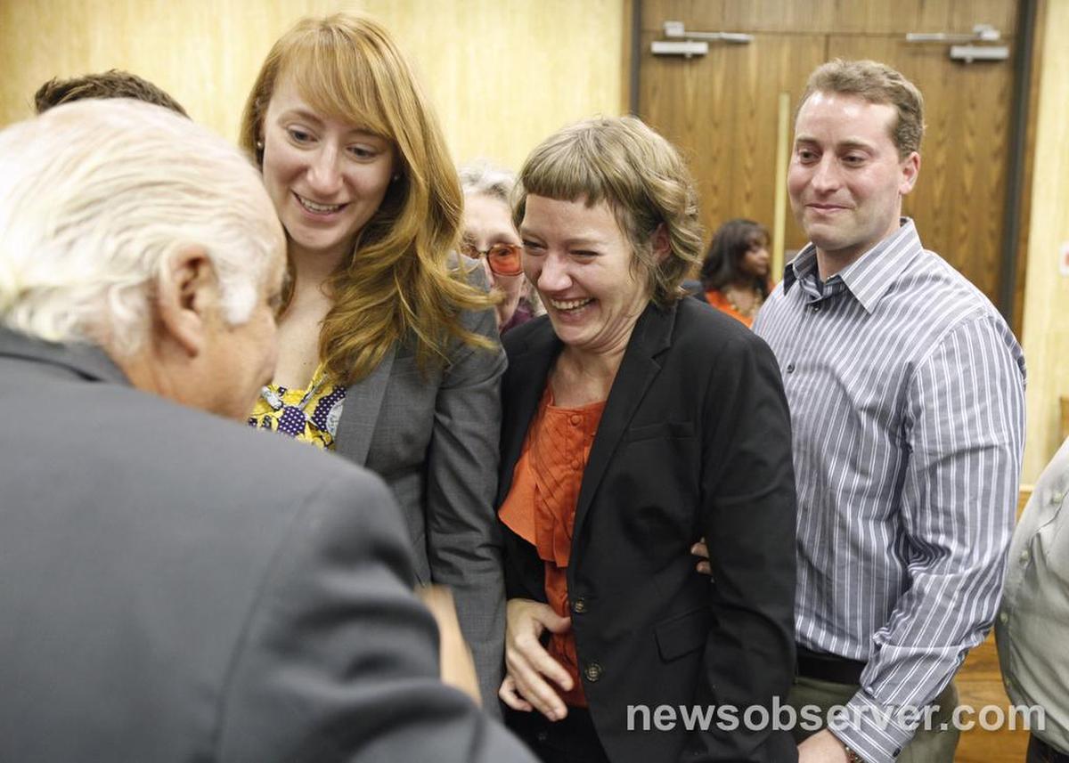 Michael Peterson’s daughters Margaret and Martha Ratliff and son Clayton Peterson celebrate with investigator Ron Guerette after Judge Orlando Hudson ruled on Wednesday, December 14, 2011, that Peterson would get a new trial.