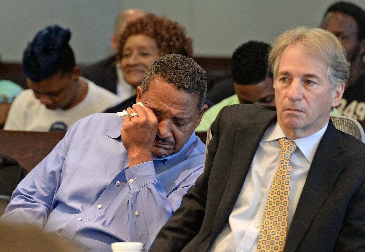 Darryl Anthony Howard (left) wipes away tears after Judge Orlando Hudson rules to vacate his murder conviction. His lawyer, Barry Scheck, co-director of the N.Y. based Innocence Project is at right.