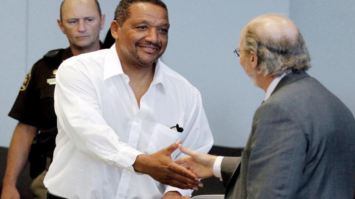 Darryl Howard, left, shakes hands with Innocence Project attorney James Cooney III, right, as Howard entered Durham Superior Court Friday morning, July 11, 2014. Hudson ordered a new trial for Howard after he found no physical evidence connecting Howard to the deaths of a mother and daughter in 1991 for which he has served 20 years in prison.