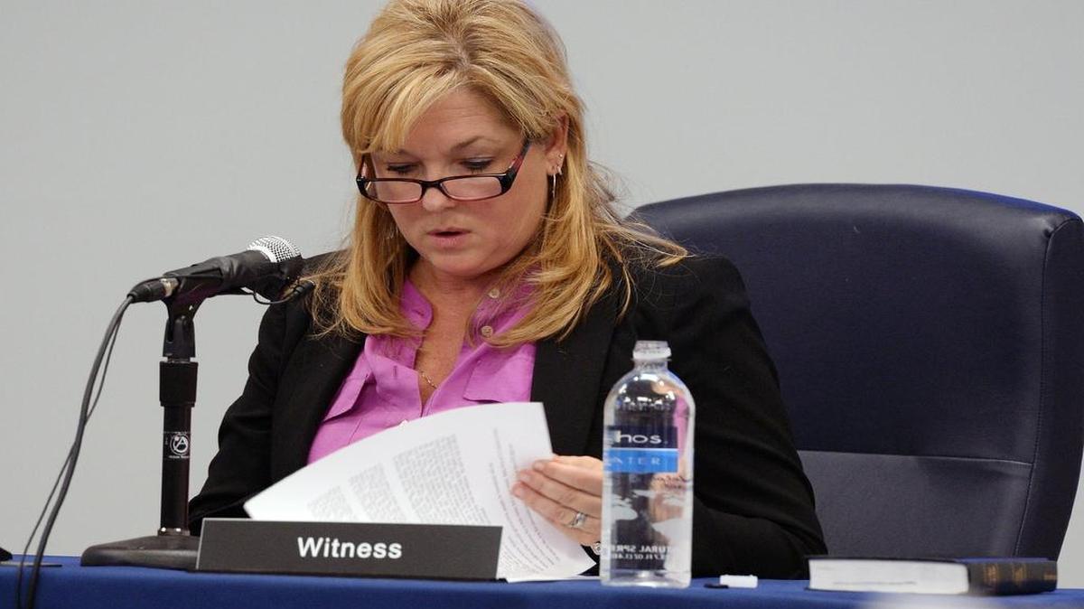 
Christine Mumma, director of the North Carolina Center on Actual Innocence, looks over an affidavit as she testifies in front of the North Carolina Innocence Inquiry Commission in Raleigh on Dec. 3, 2014. 
