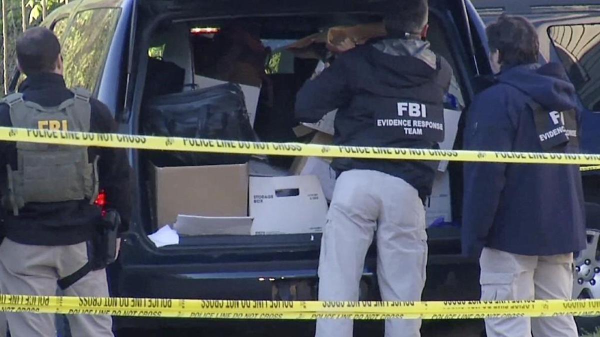 In this photo taken from video, FBI agents collect evidence at an apartment in Atlanta, April 10, 2014, where federal agents rescued kidnap victim Frank Arthur Janssen, of Wake Forest. N.C. John Strong, FBI special agent in charge in North Carolina, said the kidnapping of Janssen was related to his daughter's prosecution of North Carolina prisoner Kelvin Melton, who is serving a life sentence for his 2012 conviction for being a habitual felon.