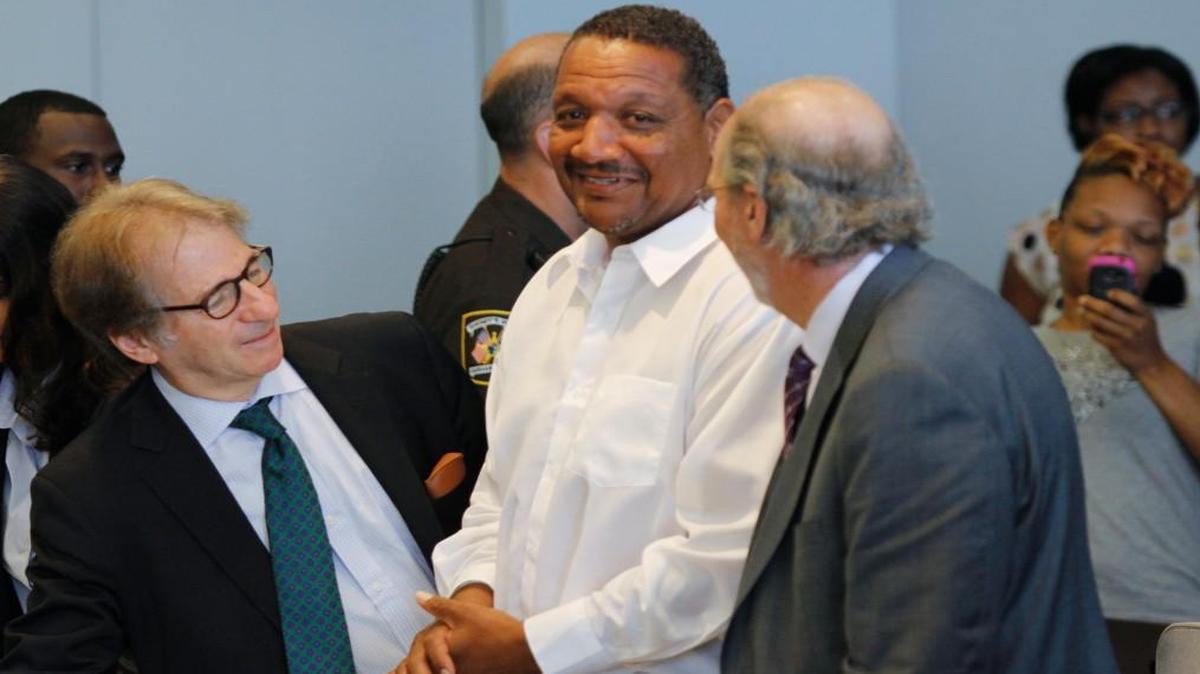 Innocence Project defense attorneys Barry Scheck, left, and James Cooney III, right, were happy for their client Darryl Anthony Howard at the end of the bond hearing for Howard in Durham Superior Court July 11, 2014. Presiding Judge Orlando Hudson said he intends to free the 52 year old Howard on unsecured bond unless he is blocked in the state appeals court. Hudson ordered a new trial for Howard after he found no physical evidence connecting Howard to the deaths of a mother and daughter in 1991 for which he has served 20 years in prison.