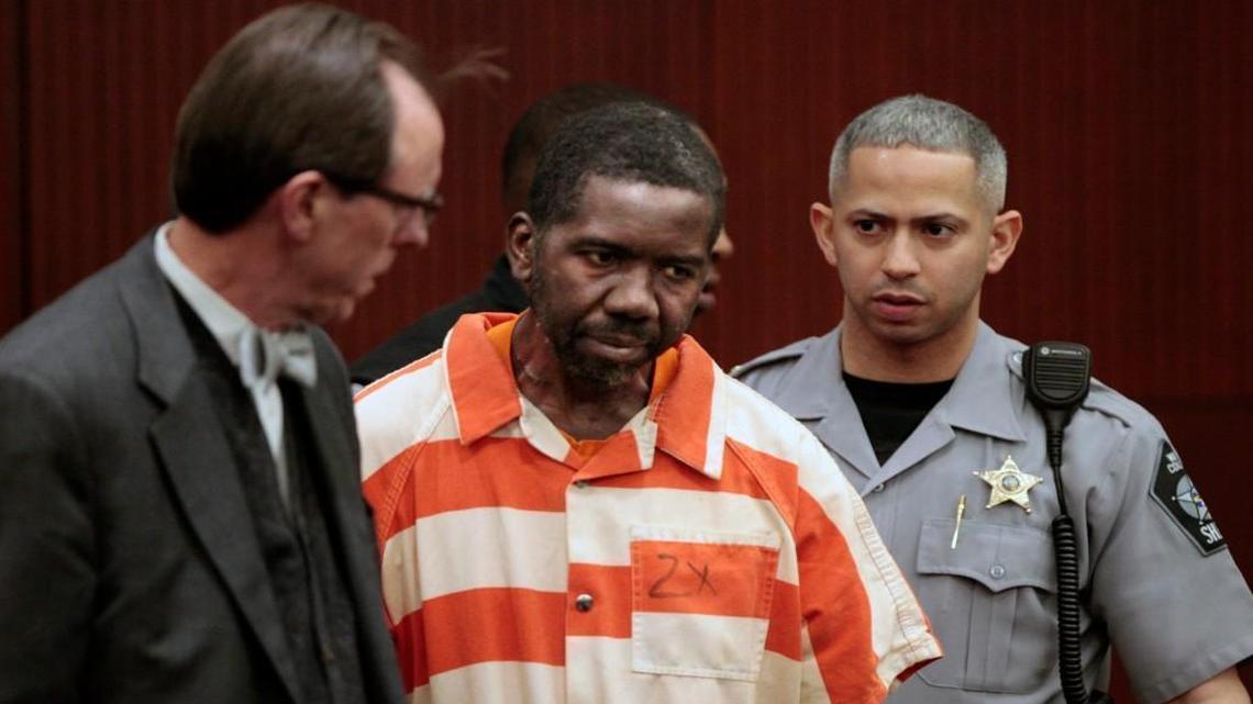 Elhadji Seydou Diop, 53, center, enters Wake County Superior Court in a 2016 first appearance hearing.
