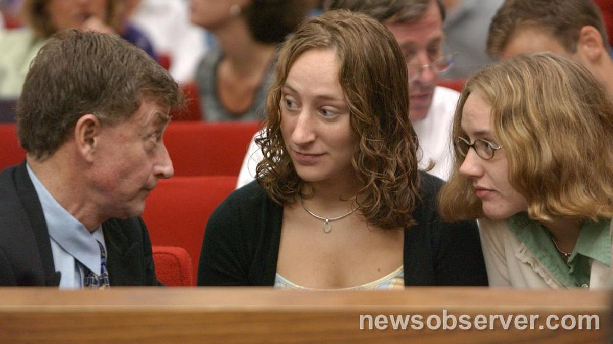 Mike Peterson, left, talks with Margaret (center) and Martha Ratliff during a break in the trial on Friday, September 5,2003.