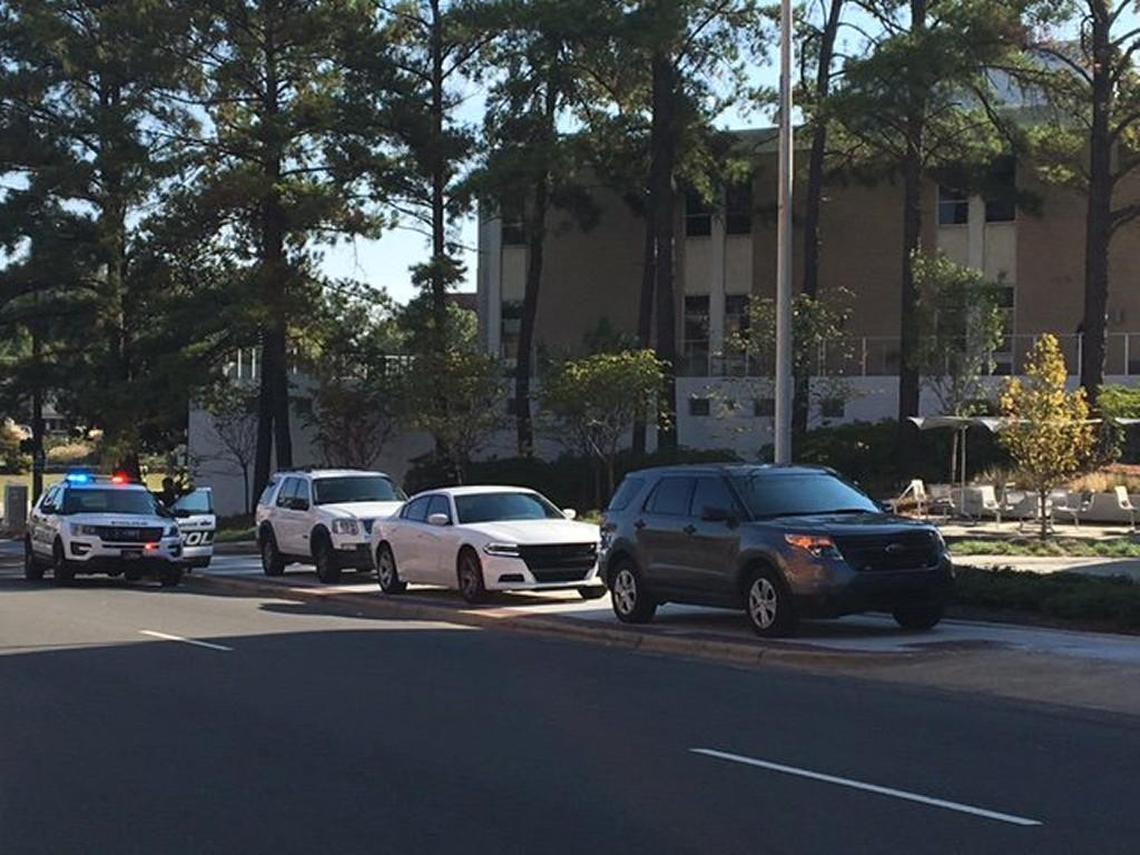 Marked and unmarked Durham, NC, police cars surround City Hall on Friday, Sept. 22, 2017, while officers evacuated the building and checked on a suspicious package found inside.