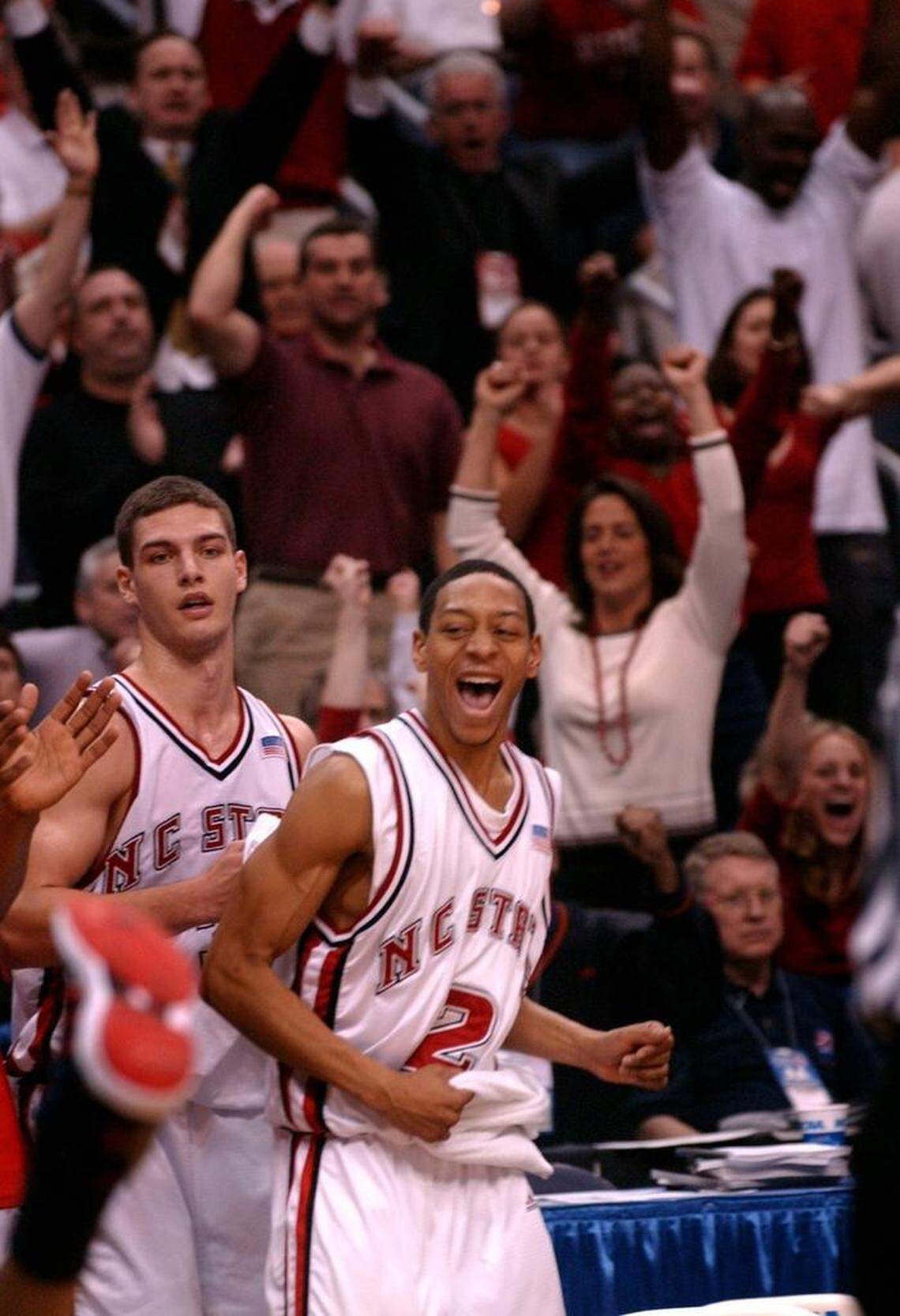 NC State’s Anthony Grundy, right, and Ilian Evtimov, left, cheer on their team from the bench in the second half of an NCAA Tournament matchup in 2002.
