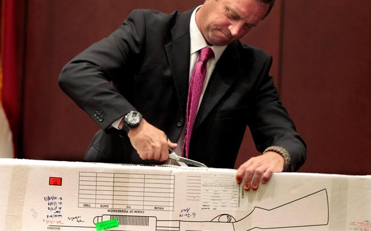 
Former Wake County Sheriff’s Office Investigator Edward Welch opens a sealed box containing a shotgun during his testimony Thursday in the murder trial of Jonathan Santillan at the Wake County Justice Center in Raleigh. The teen is accused of murdering a couple in Garner. Investigators contend they were the unintended victims in rival gang warfare.
