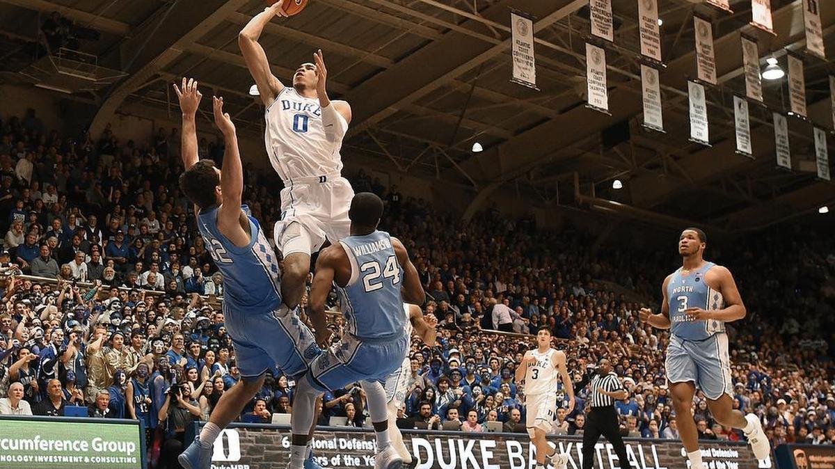 Duke forward Jayson Tatum (0) tries to split UNC forward Luke Maye (32) and teammate guard Kenny Williams (24) in the second half. Tatum was called for a foul on the play. Duke defeated UNC 86-78 at Cameron Indoor Stadium in Durham, N.C. Thursday, Feb. 9, 2017.