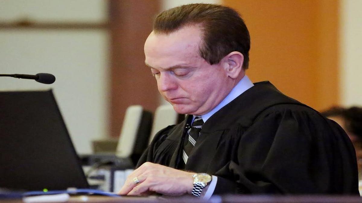 Former Wayne County judge Arnold Ogden Jones works from the bench during a trial in Goldsboro. Jones has won a new trial in a federal case in which he was convicted of attempting to bribe an FBI agent with beer and cash to obtain copies of text messages involving members of his family.
