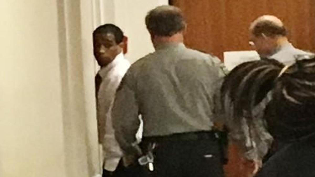 Troy Arrington (far left, rear) casts a last glance back at family and friends before exiting the Orange County Courthouse courtroom in which he'd just been sentenced to life in prison for the murder of UNC-Chapel Hill professor Feng Liu on Thursday, March 16, 2017.