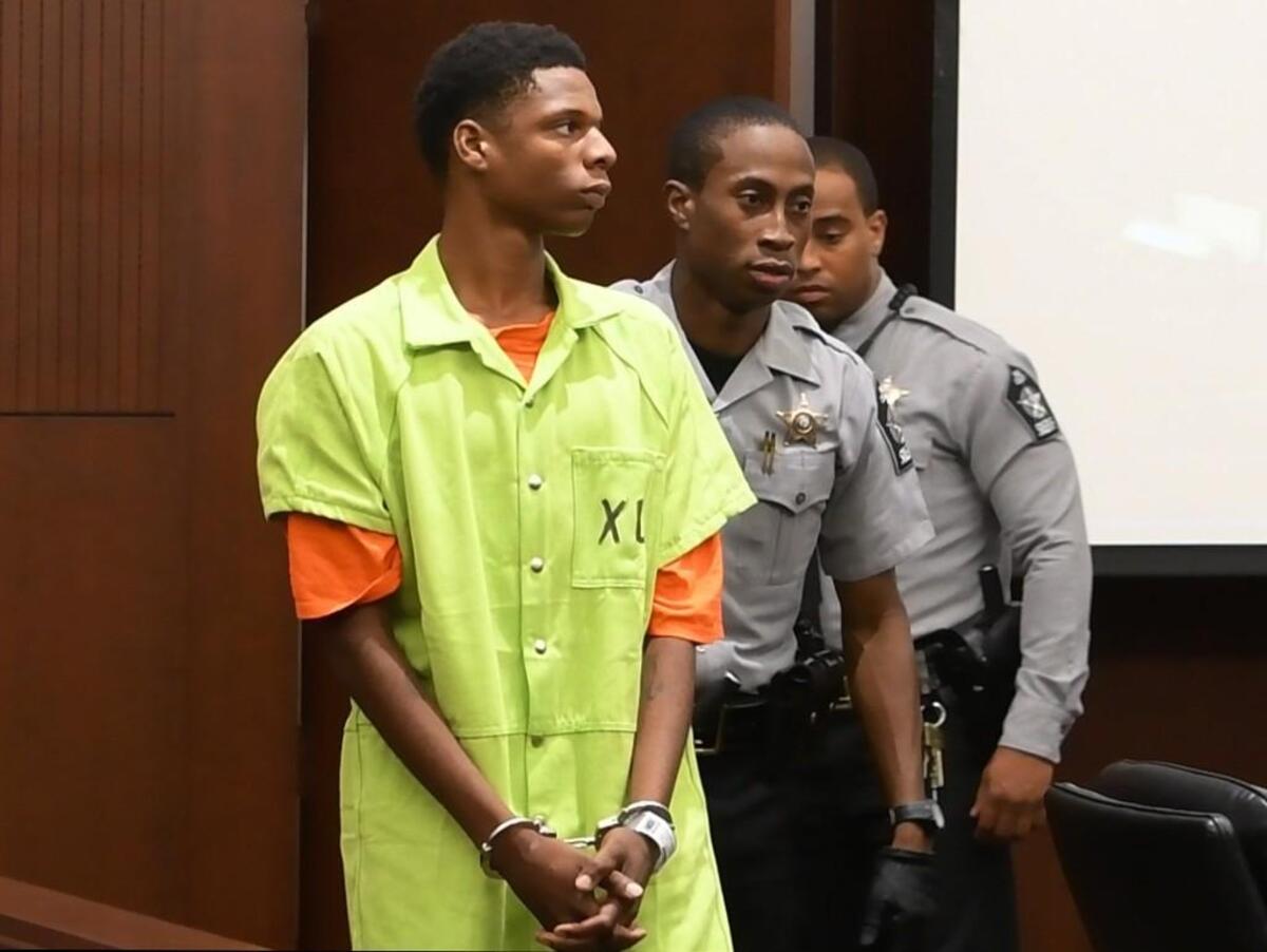 Kenneth Edward Watts, 16, is led into a courtroom by Wake County deputies as he makes his first appearance in a Raleigh courtroom Thursday, July 6, 2017.