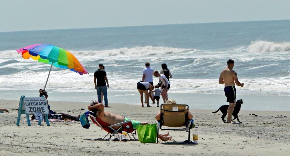 Bathers take to the beach on Atlantic Beach following Hurricane Arthur on July 4, 2014.