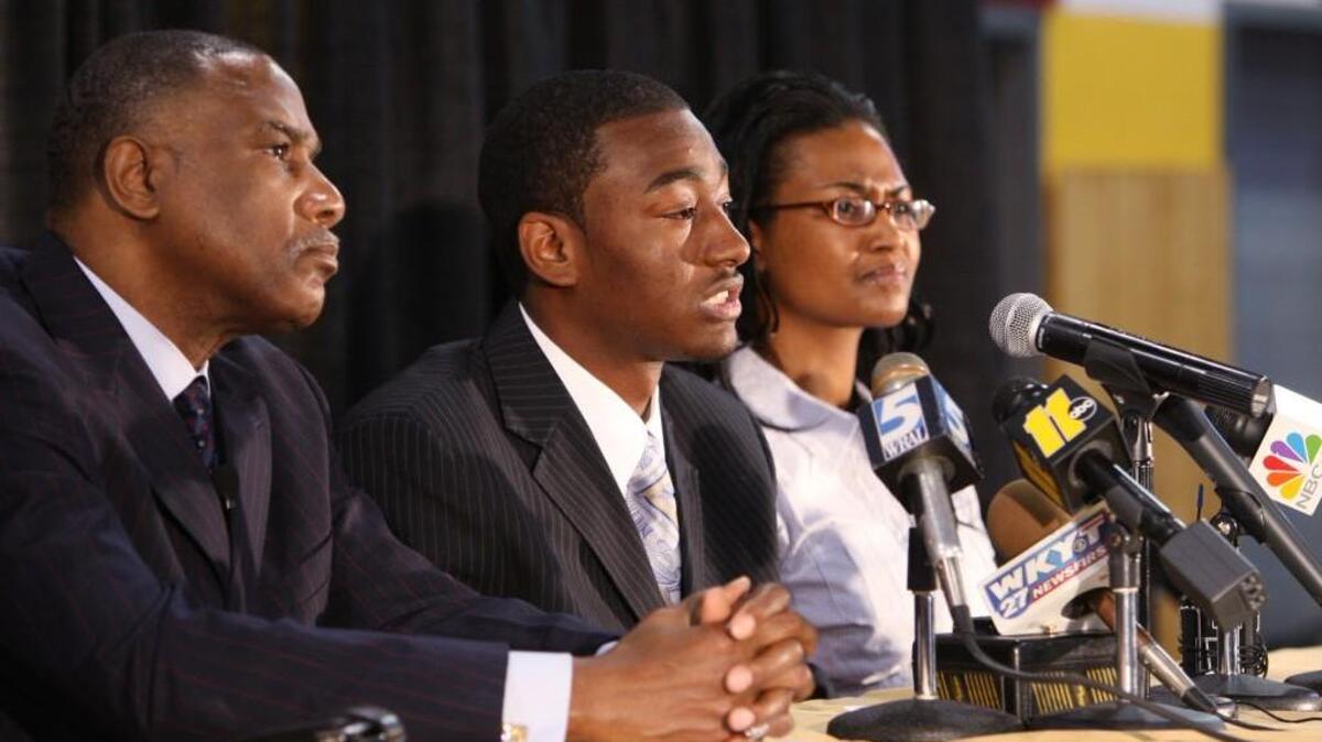 Frank Summerfield, left, with basketball star John Wall at a news conference at Word of God Christian Academy in 2009, when Wall announced he would play at Kentucky.