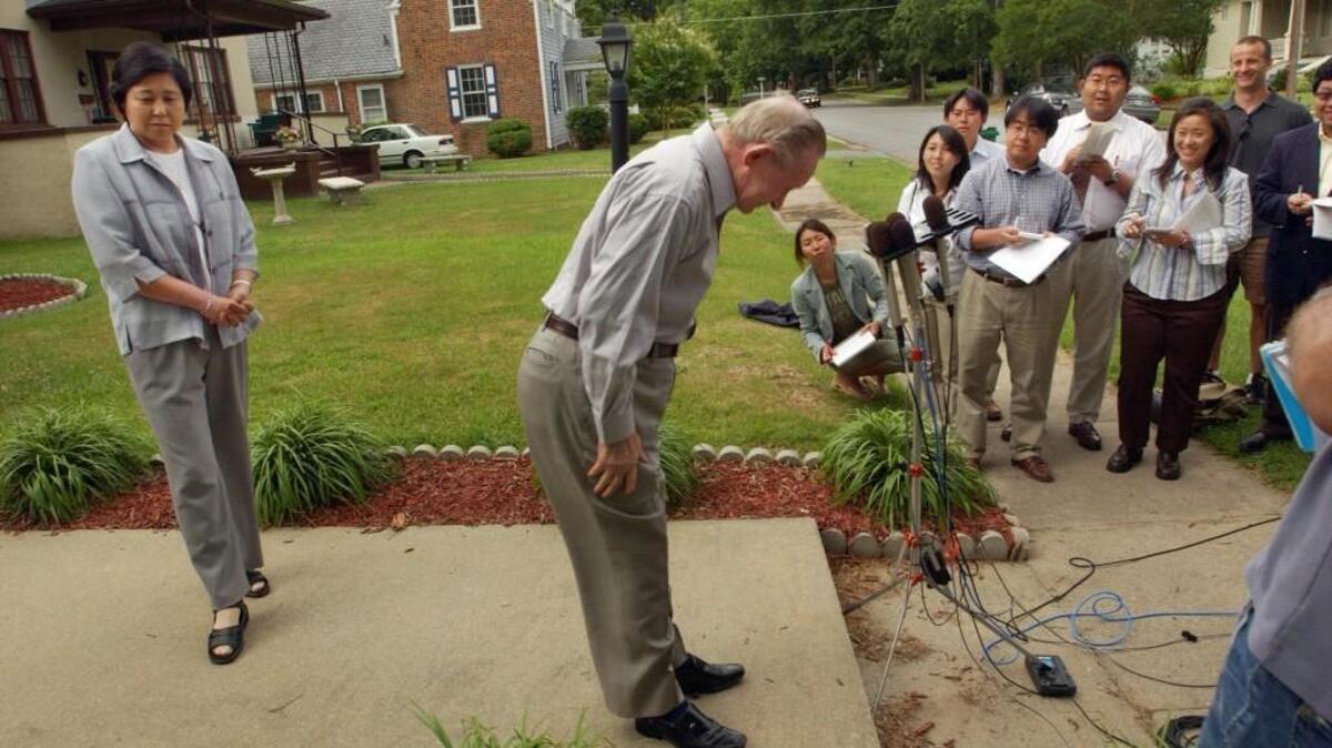Charles Robert Jenkins, center, bows to members of the media after a press conference on Monday, June 20, 2005, in front of his sister’s house in Weldon, NC. Jenkins said he is sorry he deserted the Army while stationed in South Korea in January, 1965, a decision that led to four decades of life in North Korea. His wife, Hitomi Soga stands behind him.