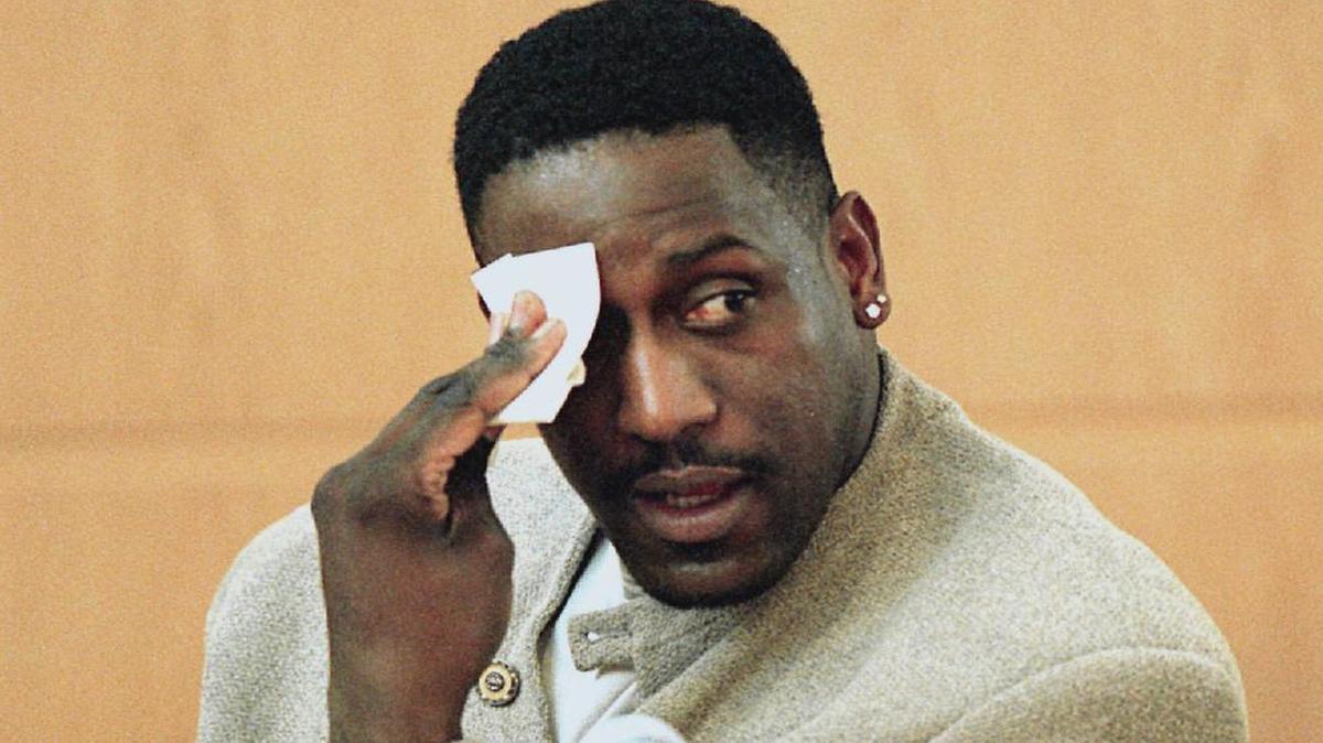 In this 2000 photo, former N.C. State basketball player Charles Shackleford wipes his forehead as he answers questions during Rae Carruth's murder trial in Charlotte.