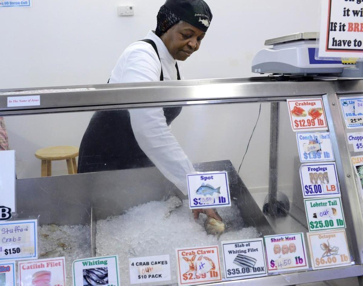 Daffene Edge working at John C's Fish Market in Hope Mills, N.C. in 2014. She is one of 10 people facing charges, according to the Cumberland County Sheriff's Office.