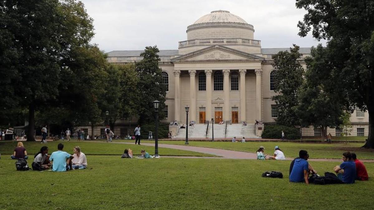 Students mingle on the quad in front of the Wilson Library on the UNC campus in Chapel Hill.