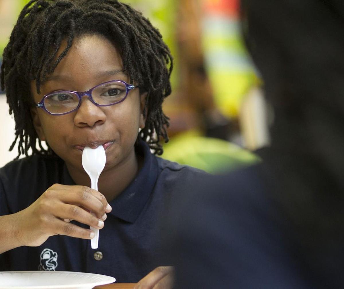 Takarah Rowland samples the filling from a cookie during a science exercise on the phases of the moon during science class at Hope Charter Leadership Academy on Thursday, November 9, 2017 in Raleigh. N.C.