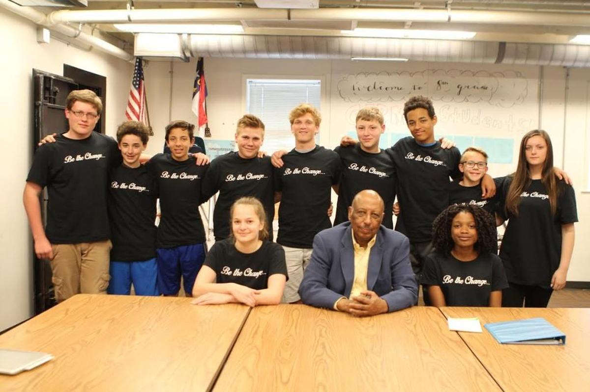 A group of eighth-grade students at The Exploris School is asking Wake County to name a future school after the Holt family, which includes Joe Holt Jr., center.