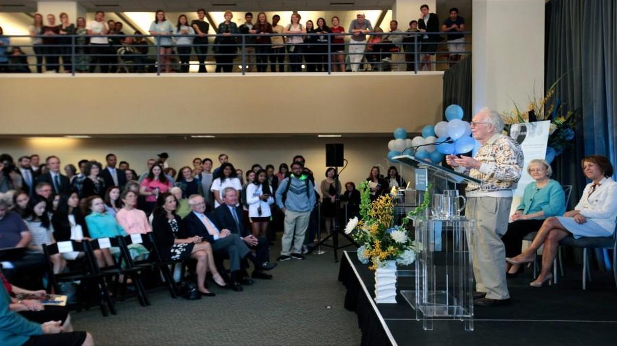 Speaking from the podium at right, 2007 Nobel prize winner Dr. Oliver Smithies addresses a large crowd gathered in UNC's Davis Library on April 13, 2016, during a ceremony kicking off the one-year display of 2015 Nobel prize winner Dr. Aziz Sancar and Smithies’ Nobel medals at UNC’s Davis Library.
