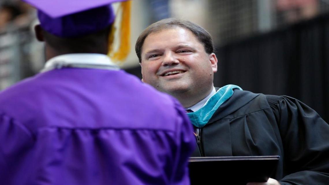 Principal Stephen Mares hands out diplomas during the Broughton High School graduation ceremony in Raleigh on June 8, 2012.
