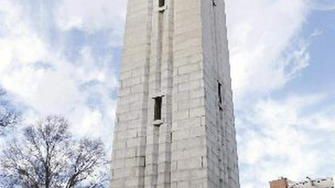Graduates pose in front of NC State's Bell Tower on Hillsborough Street in this December 18, 2015, file photo.