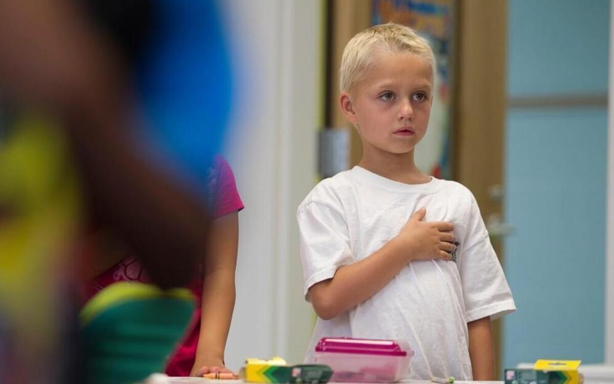 Zachary Warren a first grader at Abbotts Creek Elementary School stand for the Pledge of Allegiance in his class room on Monday, August 24, 2015 in Raleigh, N.C.
