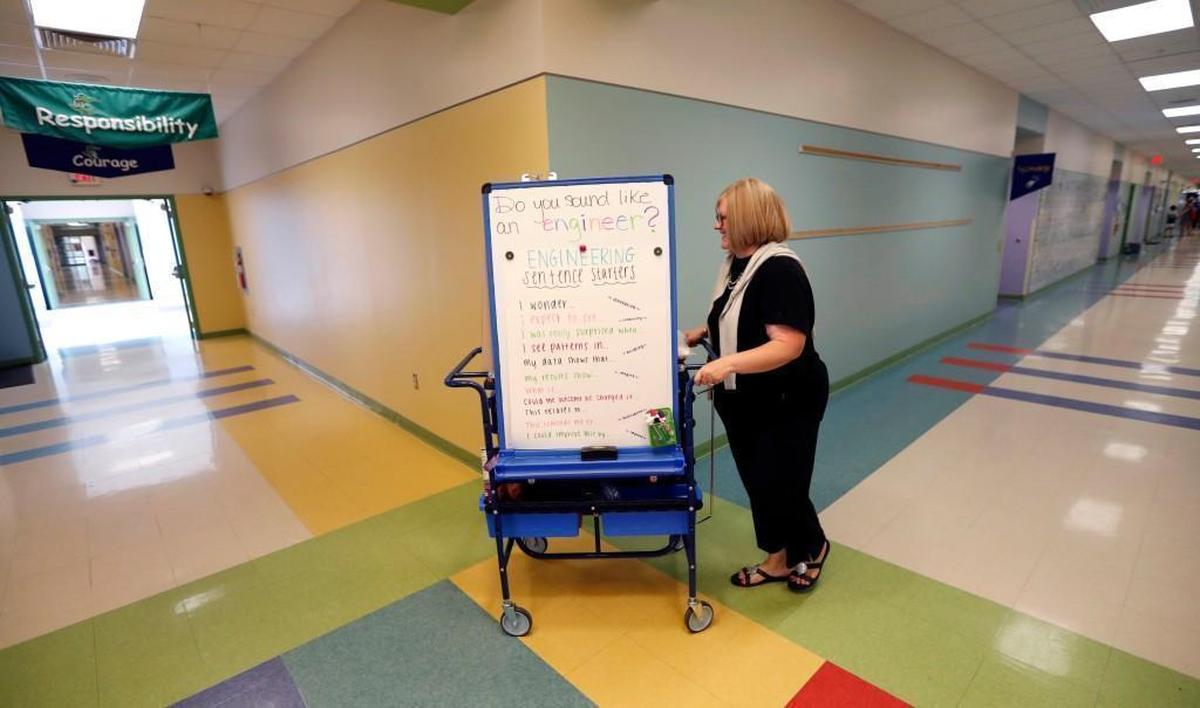 Engineering specialist Stephanie Wright takes her cart through the halls at Sycamore Creek Elementary School in Raleigh, N.C., Thursday, August 24, 2017. Wright used to have a classroom but because of a new class size requirement, she now visits classrooms with a cart.