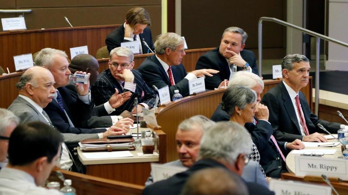 UNC Board of Governors members informally talk among themselves before the start of an emergency meeting October 16. The board went into closed session right after starting the meeting.