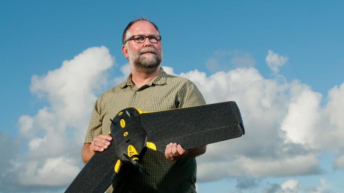 Duke associate professor Dr. Dave Johnston holds a senseFly eBee, a 1.5 lb foam research drone that is a workhorse of the UAS facility’s marine science and conservation studies.