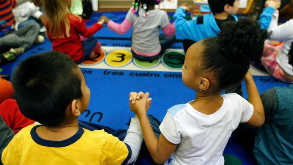 Preschool students join hands as teachers Michele Dutton and Nekia Riley use puppets to help improve classroom management and student behavior, while building children's social-emotional skill and positive behavior skills at Hillandale Elementary School in Durham, NC on Dec. 20, 2016. It is part of a program being developed in cooperation with the Duke Center for Child & Family Policy.