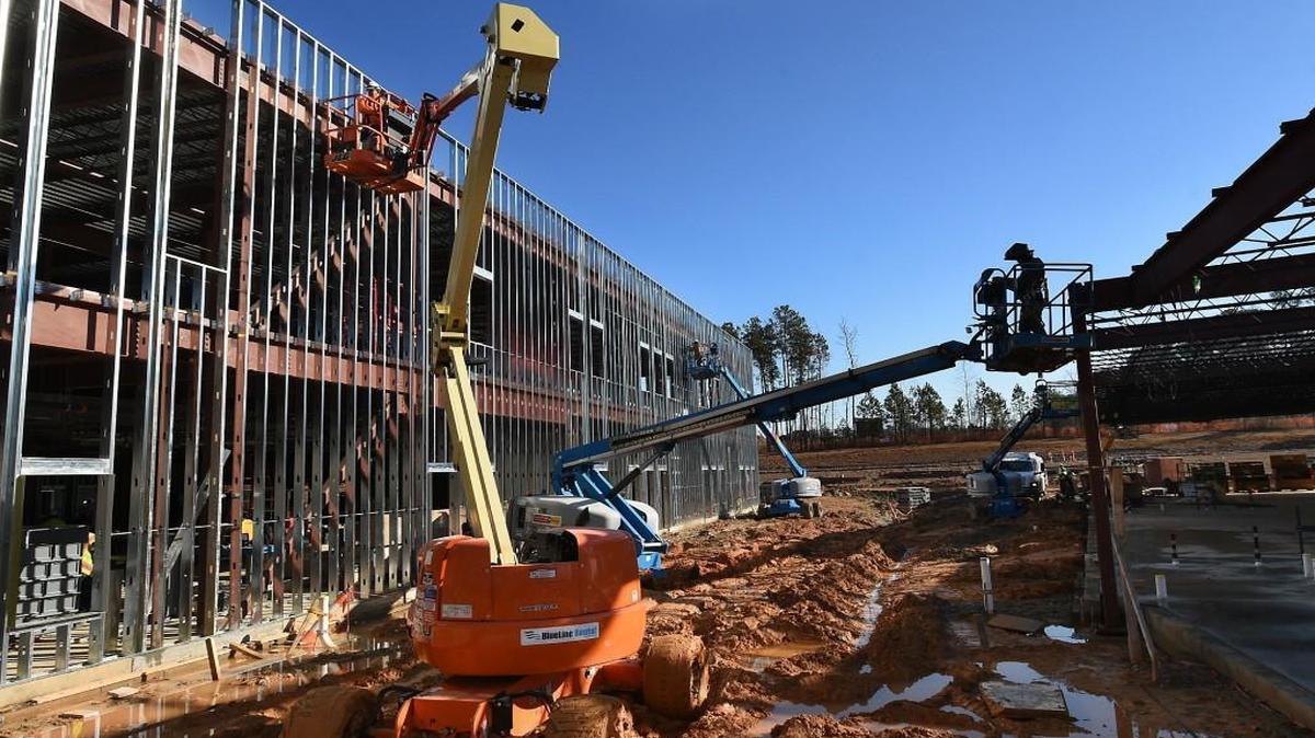 Workers use lifts to work on various areas at the new Oakview Elementary School on Dec. 8, 2015 in Holly Springs, N.C. Oakview was funded from the school bond referendum approved by voters in 2013. Wake County leaders are considering whether the next bond referendum should be in 2016 or 2018.