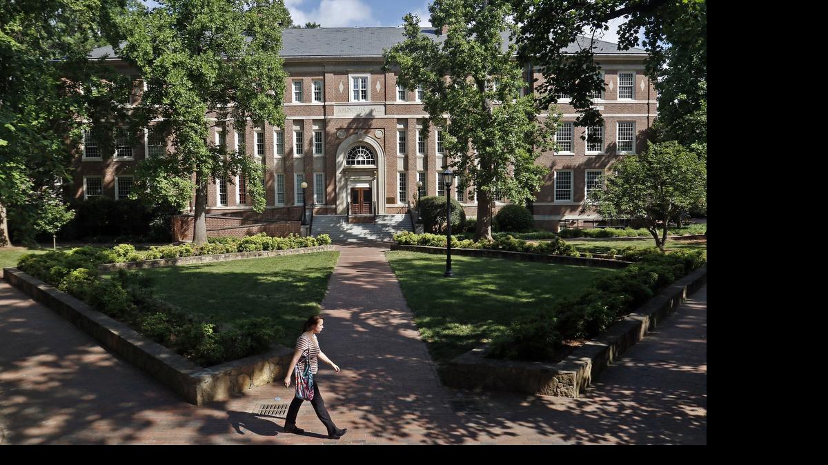 
Front exterior of Saunders Hall, background, as seen across the quad from the steps of Murphey Hall on the UNC-CH campus Wednesday, May 27, 2015. Saunders Hall, completed in 1922 is named for UNC class of 1854 graduate William Lawrence Saunders. UNC student leaders have been pushing for months to have Saunders Hall renamed because of Saunders' reported membership in the Ku Klux Klan. The push is to rename the building Hurston Hall, in honor of the black writer Zora Neale Hurston. 
