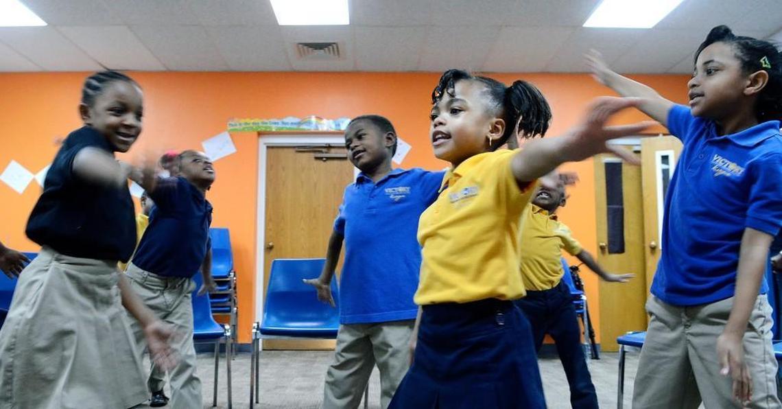 Nariah Hunter (center right), 7, dances with classmates as they sing in music class in this 2016 file photo. Her family used a North Carolina Opportunity Scholarship to attend Victory Christian Center School.
