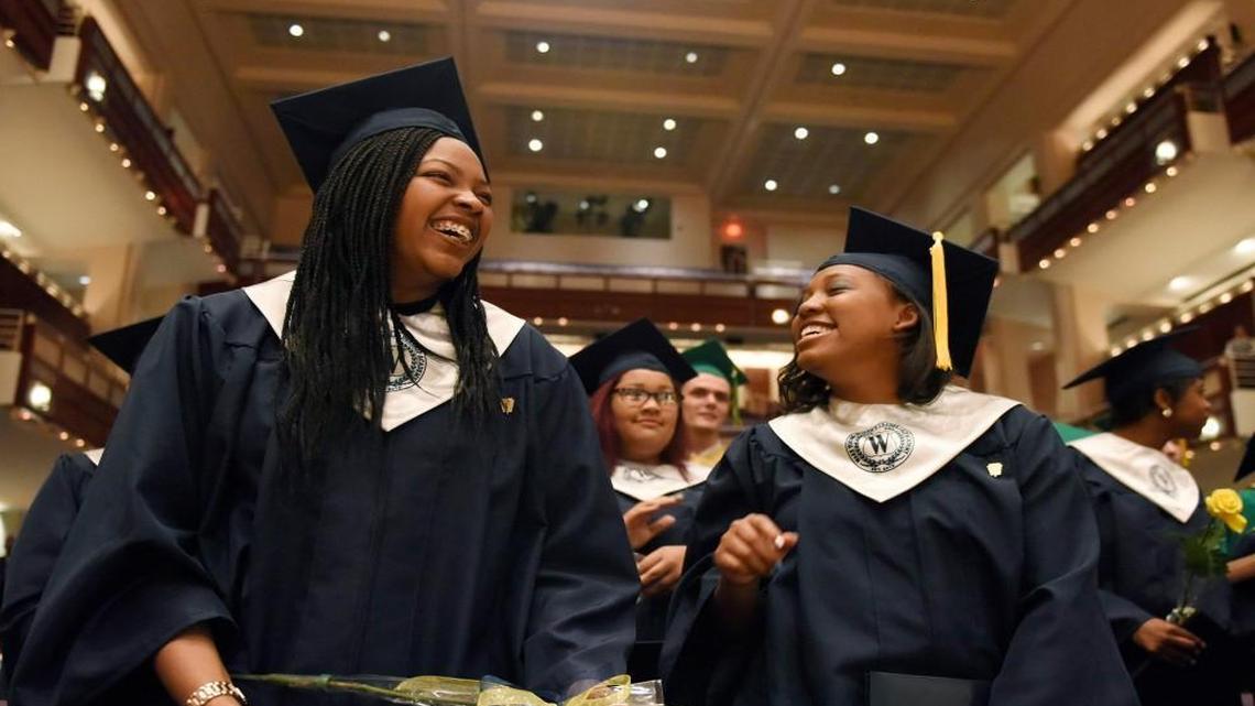 Graduates Yahnae Jones, left, and Sumera Ingram celebrate after turning their tassels during their graduation ceremony for the Wake Young Women's Leadership Academy in Raleigh on Tuesday, May 24, 2016.