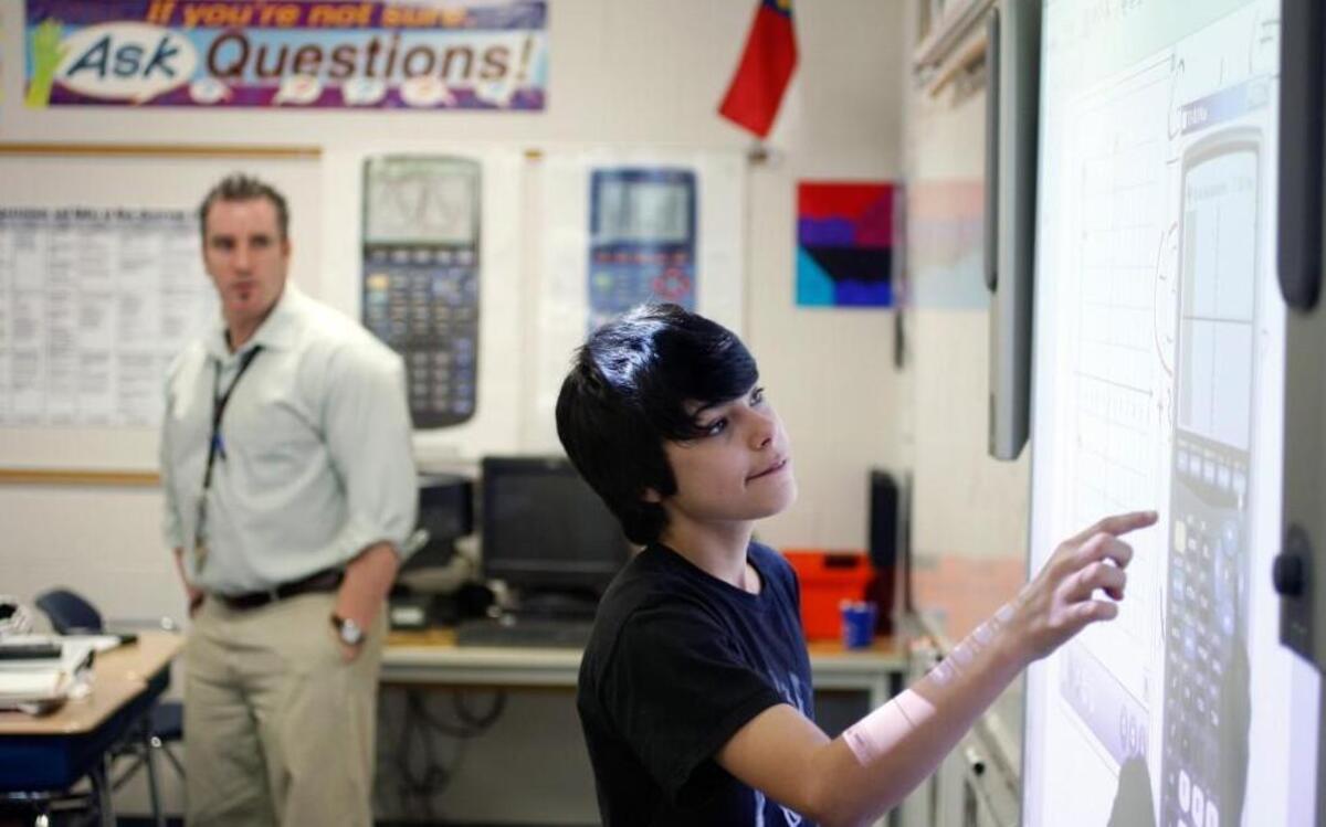 A West Millbrook Middle School eighth-grader uses the calculator on a Smart Board while solving an algebra problem in this 2012 file photo.