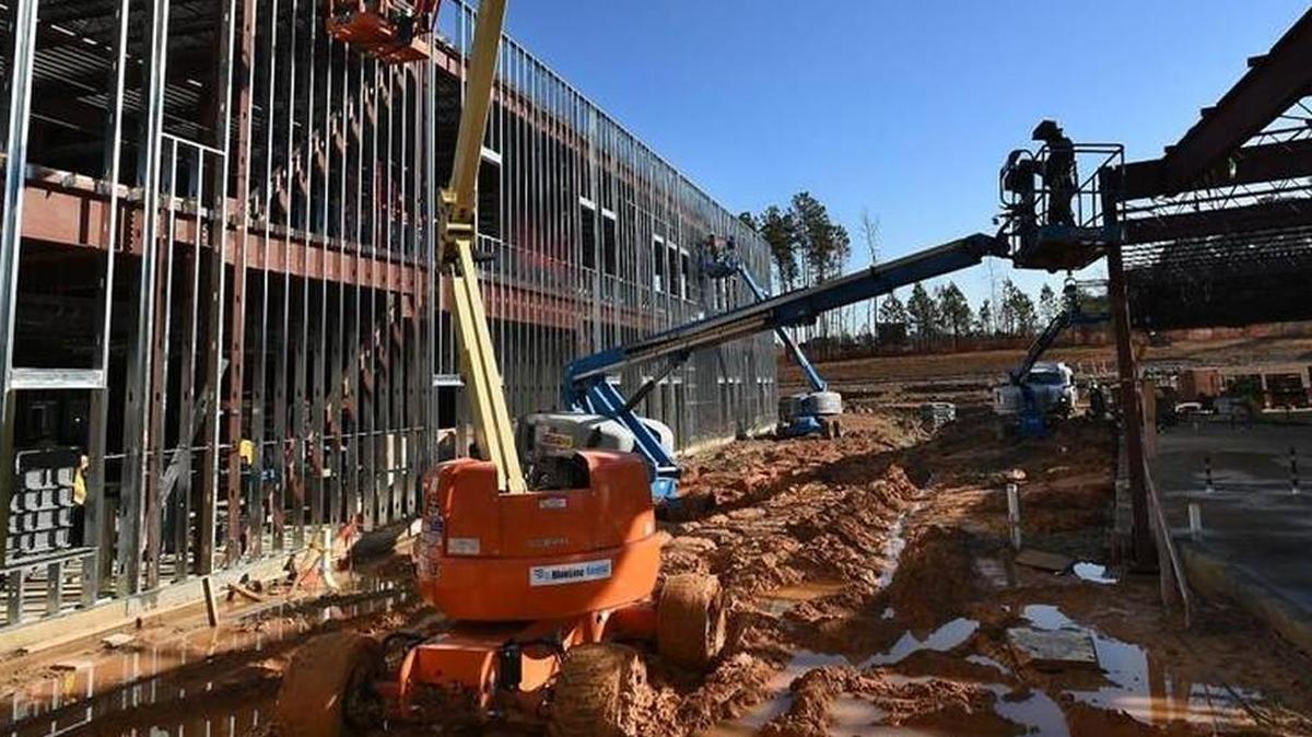 Workers use lifts to work on various areas at Oakview Elementary School in 2015 in Holly Springs. Wake County voters are expected to be asked to approved a new school bond issue in November.