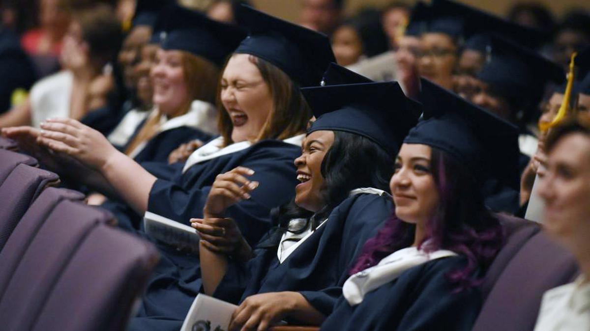 Brittany Bass, center, and Teresa Basaves, right, react to a classmate’s speech during the graduation ceremony for the Wake Young Men’s Leadership Academy and Wake Young Women’s Leadership Academy in Raleigh, N.C. on Tuesday, May 24, 2016.