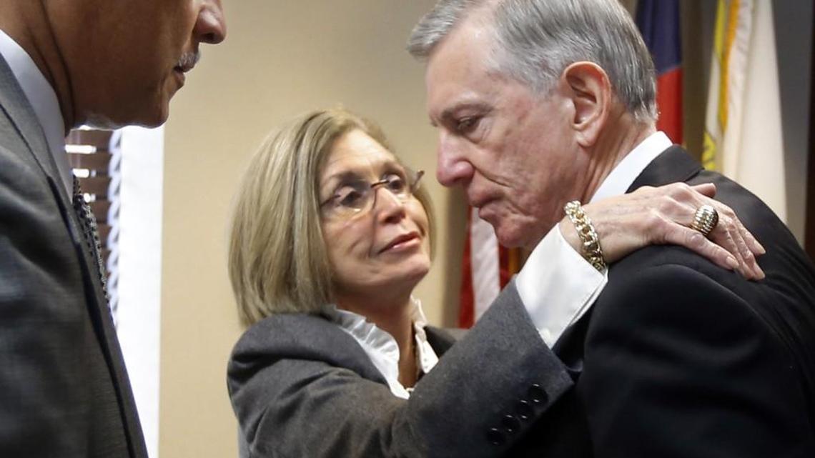 
As North Carolina A&T Chancellor Harold Martin, Sr., left, waits, board member Joan G. MacNeill gives University of North Carolina system President Tom Ross a hug after Ross's departure was announced by the UNC system's Board of Governors during a meeting at General Administration Board Room Friday, Jan 16, 2015. 
