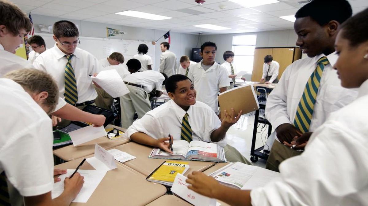 Joshua Cooley, center, looks for answers with classmates during a scavenger hunt during a social studies class on the first day of the boys-only Wake Young Men’s Leadership Academy in Raleigh on Monday, August 13, 2012.