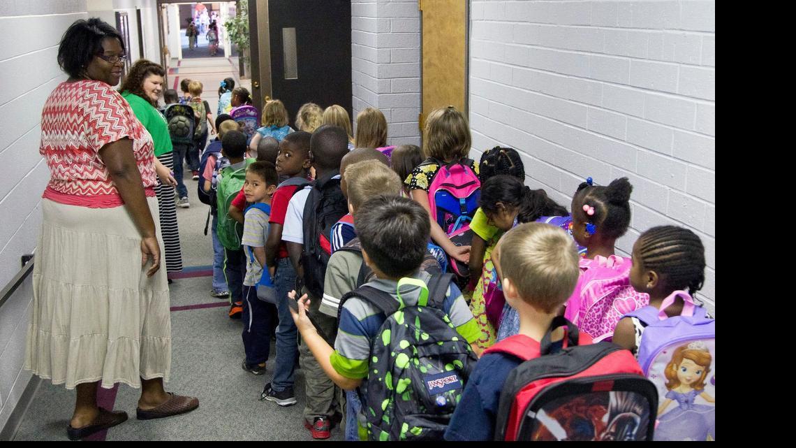 
Teachers usher elementary students down the hall as they head for home at the end of the school day on the private school campus of Raleigh Christian Academy in Raleigh on August 21, 2014. 
