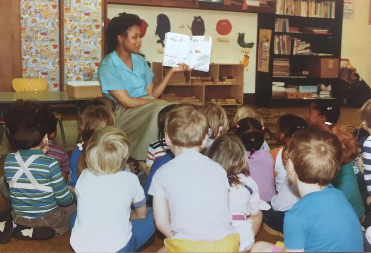 Paulette Hicks, director of the Athens Drive Child Development Center in Athens Drive High School in Raleigh, N.C., reads a story to the children in this 1980s photo.
