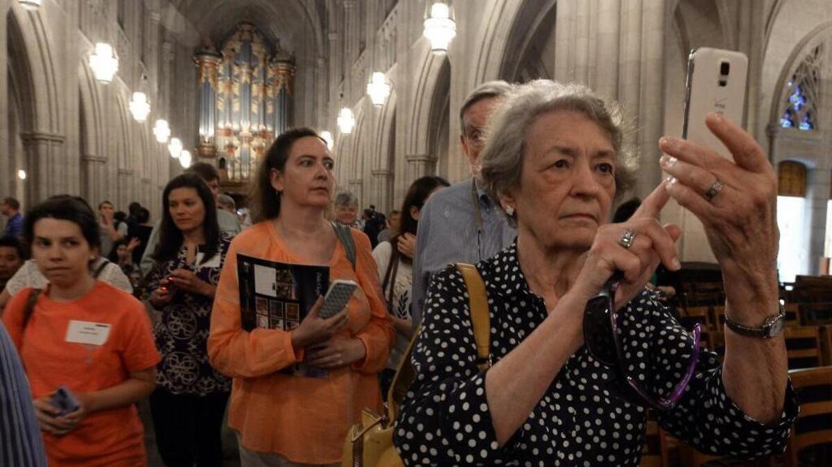 Mary Jane Laumer, of Auburn, Al. takes a photo of the altar in the Duke Chapel during the reopening ceremony in Durham, N.C. Wednesday, May 11, 2016. The chapel was closed for exactly one year as the first extensive renovations were done on the building which was originally completed in 1935.