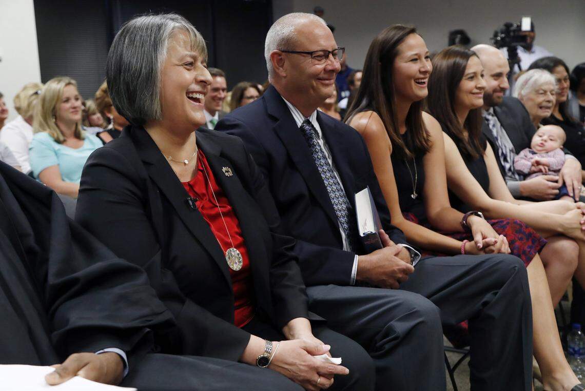 Cathy Moore, left, is announced  as the new Superintendent during a meeting at the Wake County School board headquarters in Cary on May 23, 2018.  Her husband, Tommy Moore, is next to her.