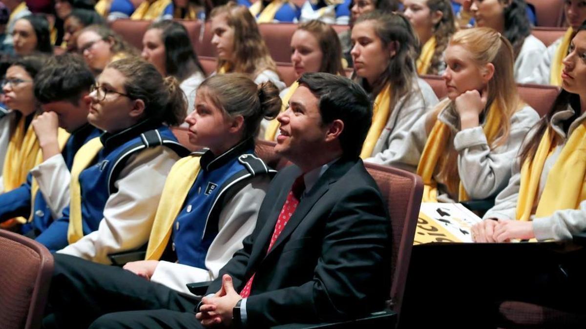 State Superintendent of Public Instruction Mark Johnson, center, sits with charter school students as he watches one of the presentations at a school choice rally on Jan. 23.