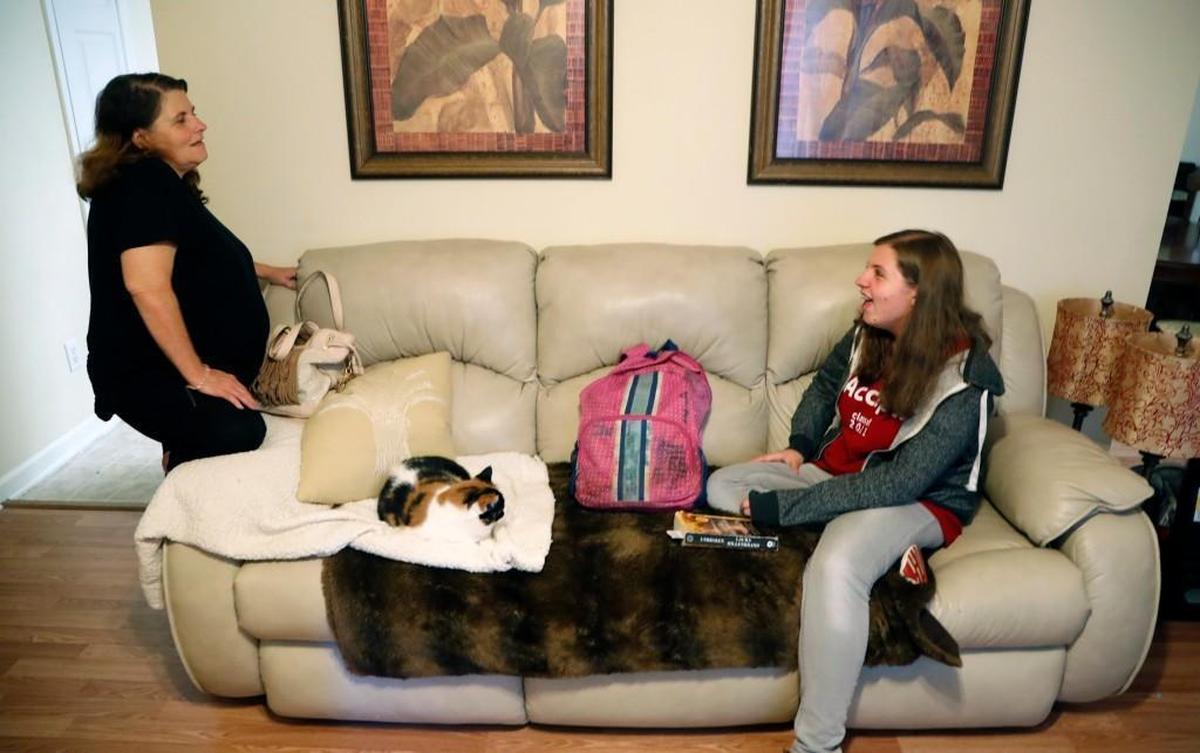 East Wake High School senior Megan Faircloth, right, chats with her mom Melba Faircloth at their home after school in Wendell, NC, on June 5, 2017. Megan spoke at a recent awards ceremony about being homeless during her junior year. She persevered through the adversity to achieve the highest class rank and received a near-full scholarship to Stanford Univ.
