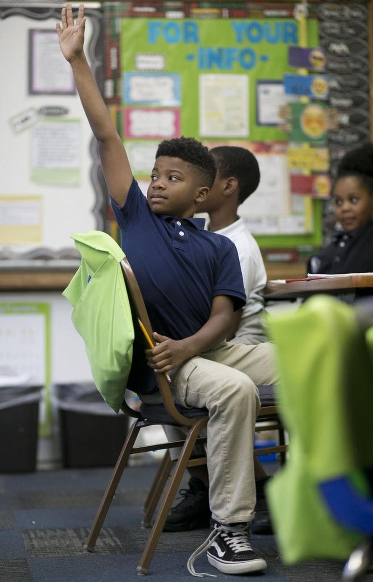 Cory Melvin a fourth grader at Hope Charter Leadership Academy raises his hand to answer a question during science class on Thursday, November 9, 2017 in Raleigh.